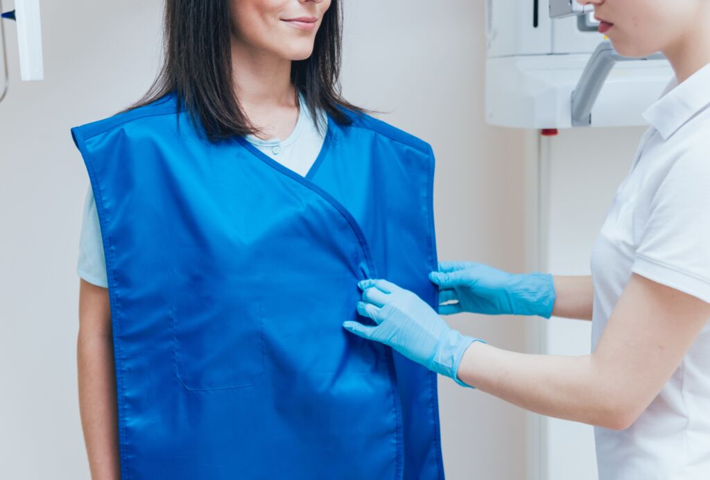 Young woman patient standing in x-ray machine. Panoramic radiography